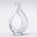 Ribbon decanter, a closed loop of clear crystal crossing itself under a short neck