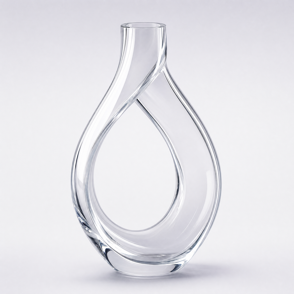 Ribbon decanter, a closed loop of clear crystal crossing itself under a short neck