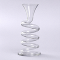 Helix decanter, a clear crystal tube coiled in open turns with a flared neck