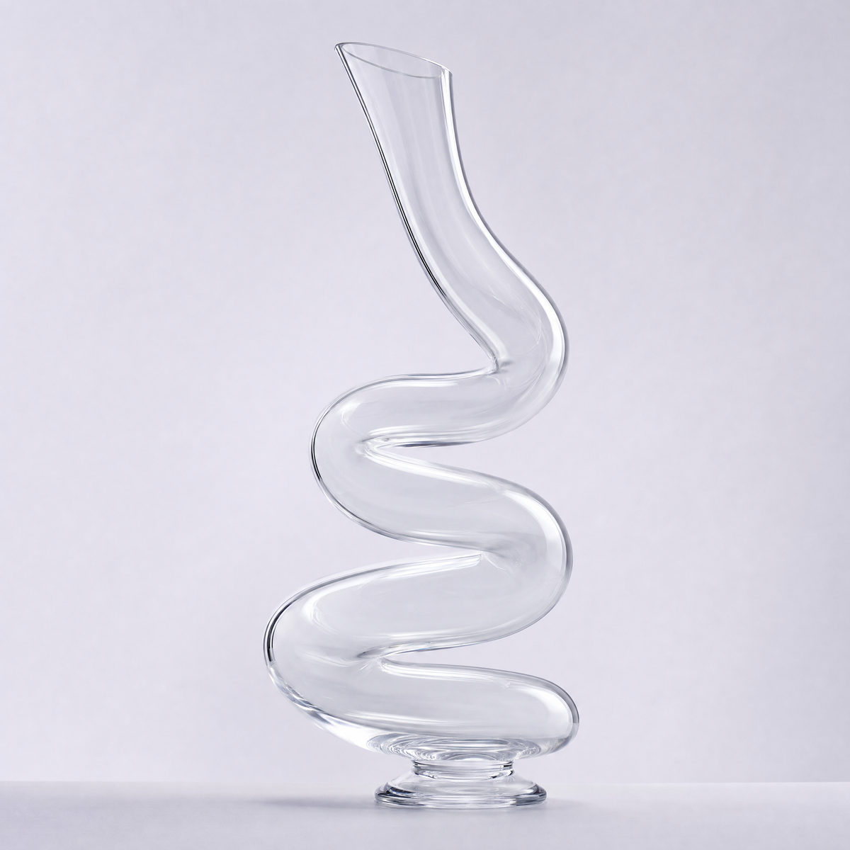 Serpentine decanter, a continuous S-curve of clear crystal on a small disc foot