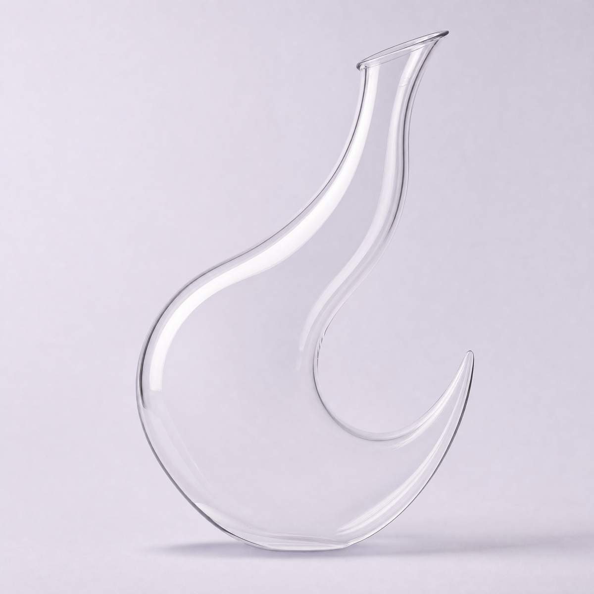 Crescent decanter, a hooked curve of clear crystal balanced on its lower horn