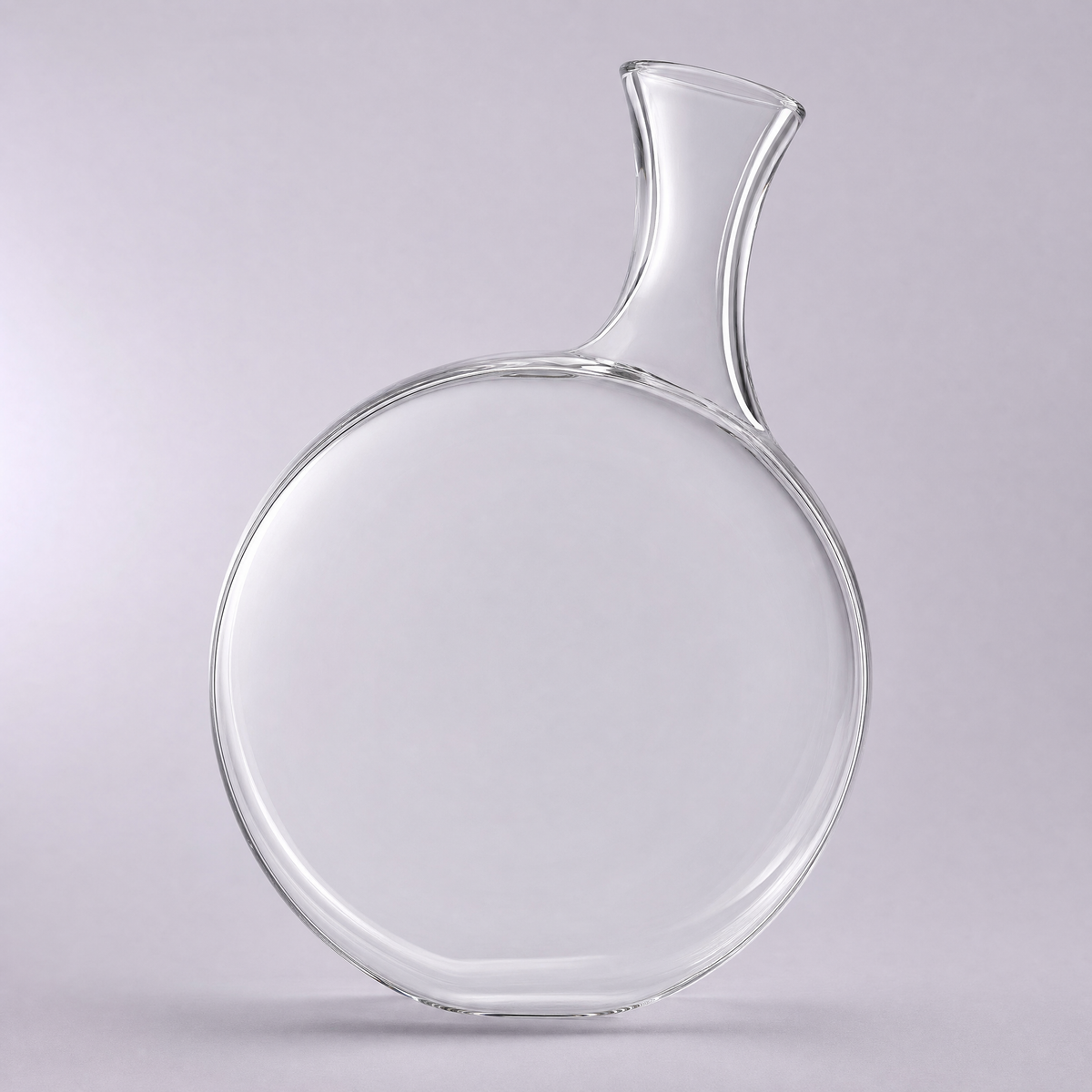 Harbour decanter, a flat round crystal disc with a slim neck rising from one shoulder