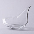 Meridian decanter, a low wide crystal bowl with a long drawn pouring spout