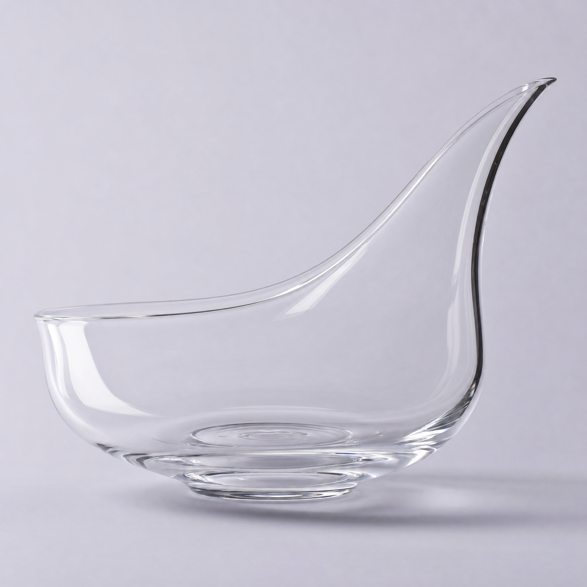 Meridian decanter, a low wide crystal bowl with a long drawn pouring spout