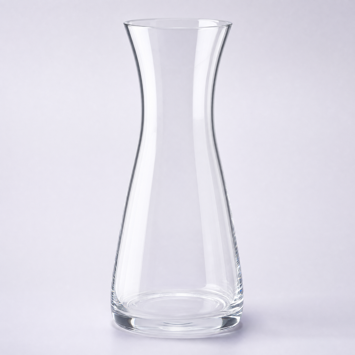 Cove carafe, a slim waisted crystal cylinder flaring at the base and the open top